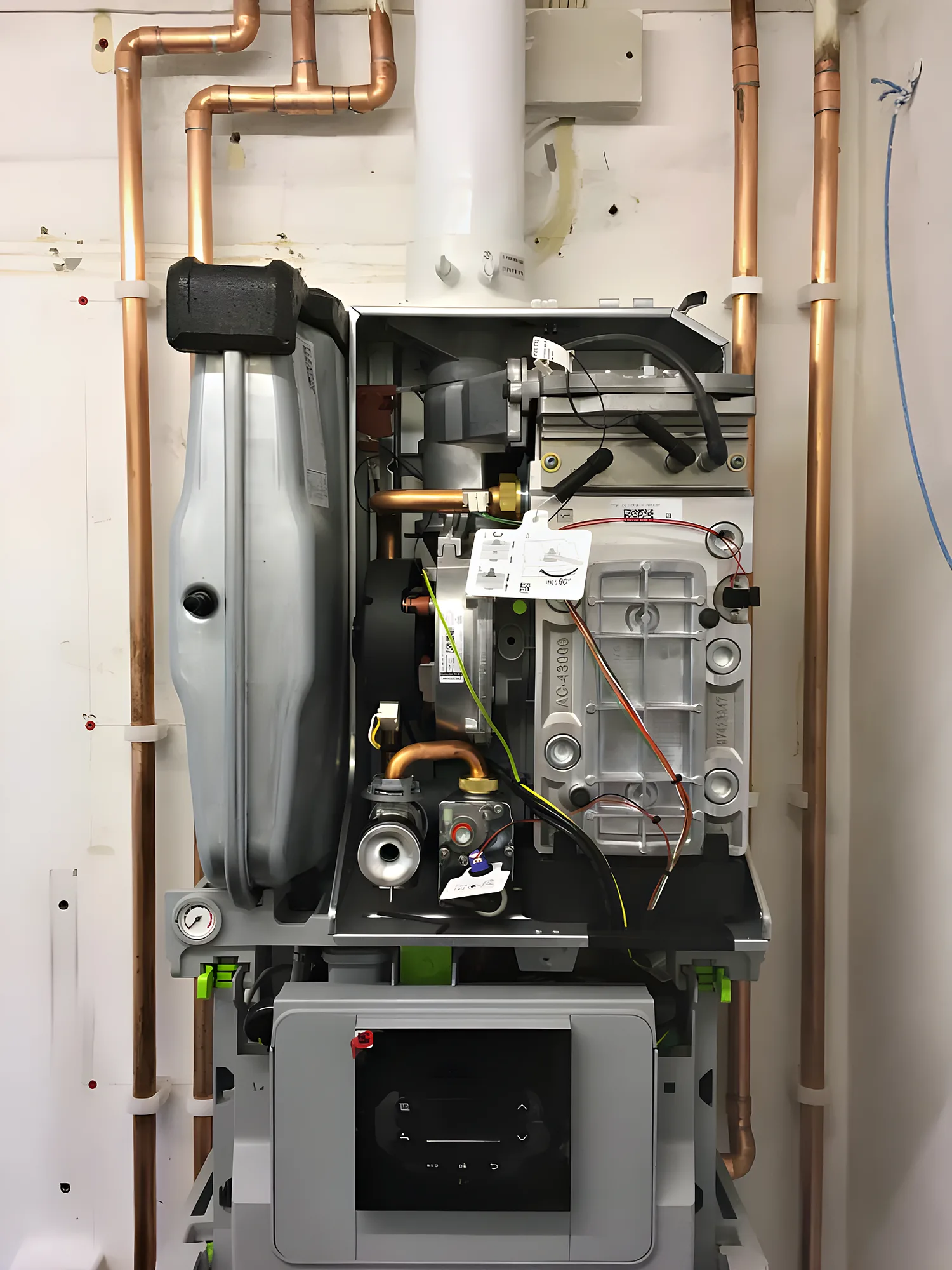 A boiler opened up for servicing, showing the burner and internal parts
