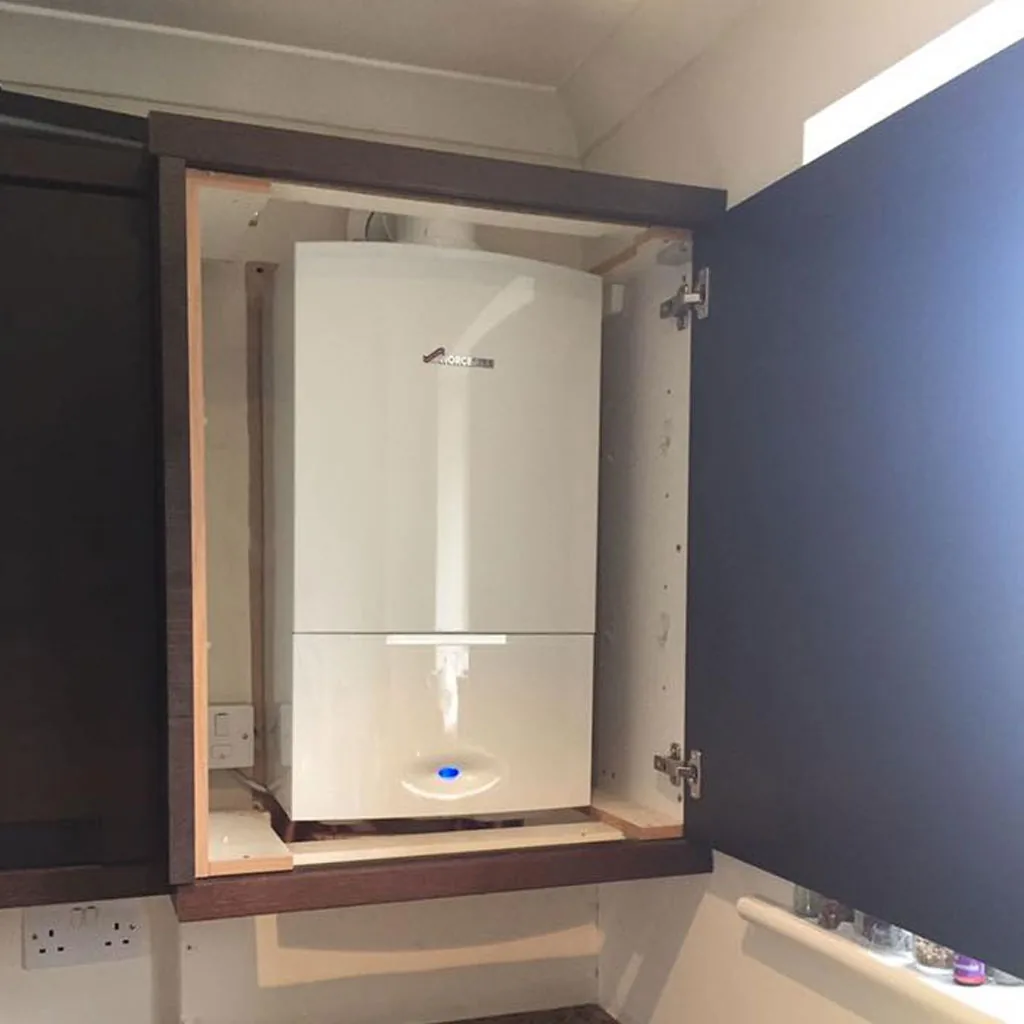 A Worcester Bosch boiler fitted inside a navy kitchen cabinet