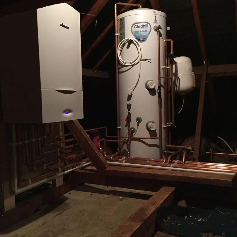 A Worcester Bosch boiler and a Gledhill unvented cylinder fitted in a loft with new copper pipework