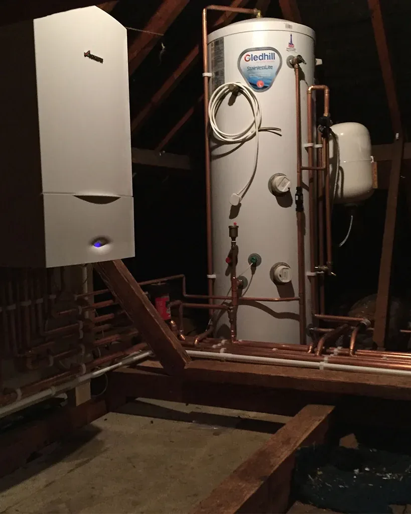 A Worcester Bosch boiler and a Gledhill unvented cylinder fitted in a loft with new copper pipework